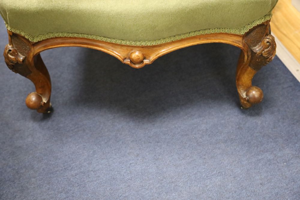 A Victorian carved walnut nursing chair